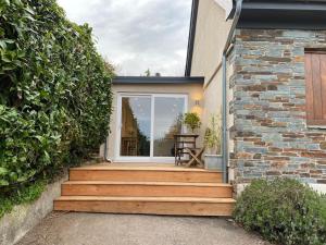 a set of wooden stairs leading to a house at Ashcroft Apartment - Small Home Away From Home in Ashburton