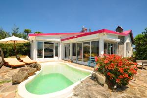 a swimming pool in front of a house at Villa Lorizon in Rodrigues Island