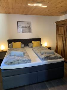 a large bed with two pillows on top of it at Ferienwohnung "Beim Dôneslar" in Bad Oberdorf