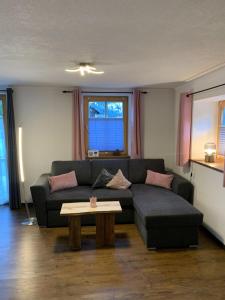 a living room with a couch and a coffee table at Ferienwohnung "Beim Dôneslar" in Bad Oberdorf