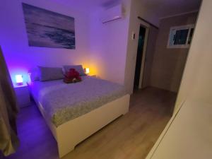 a bedroom with a bed with a teddy bear on it at BLU in Puerto del Carmen