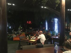 a group of people sitting at tables in a restaurant at Avatar Railay in Railay Beach