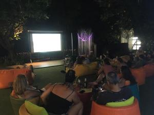a group of people sitting in chairs watching a screen at Avatar Railay in Railay Beach