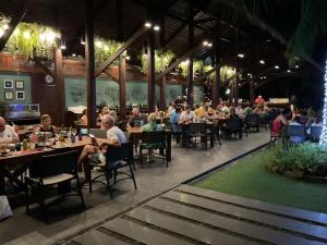 a group of people sitting at tables in a restaurant at Avatar Railay in Railay Beach