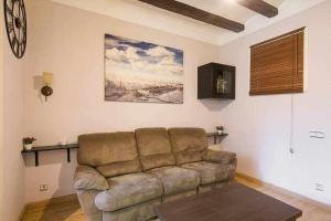 sala de estar con sofá y reloj en la pared en Consell Cent apartment I 3 dormitorios Eixample, en Barcelona