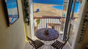 a balcony with a table and a view of the beach at Sea view 3-bedroom flat in Puerto de Mazarron in Puerto de Mazarrón
