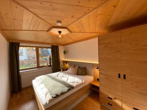 a bedroom with a bed and a large window at Appartement Kollingwald in Saalfelden am Steinernen Meer
