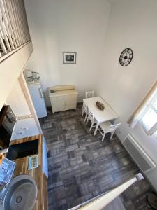 an overhead view of a kitchen with a table and a clock at Les Remparts in Saint-Martin-de-Ré