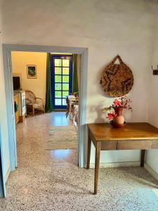 a living room with a table and a door at Cottage Apartment Othellos in Kalavasos