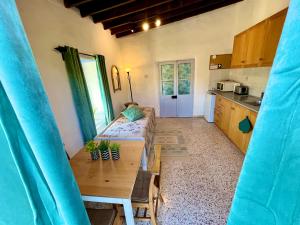 a living room with a couch and a table at Cottage Apartment Othellos in Kalavasos