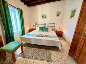 a bedroom with a bed with two towels on it at Cottage Apartment Othellos in Kalavasos