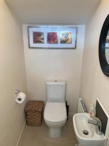 a bathroom with a white toilet and a sink at Cheerful Home FOR FOOTBALL, DOCKS AND CITY CENTRE in Liverpool
