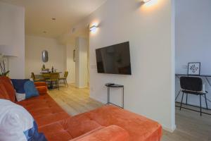 a living room with a couch and a flat screen tv at MILAN Lux Apartment-Hosted by Sweetstay in Milan