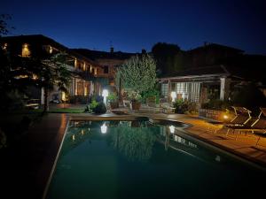 a house with a swimming pool at night at Heidi Bed and Breakfast in Albavilla