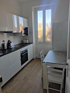 a kitchen with white appliances and a table with chairs at T2 neuf tout équipé, climatisé in Marseille