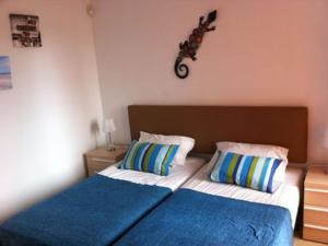 a bedroom with two beds and a motorcycle hanging on the wall at 2 Bed Sleeps 4 Pet Friendly Free Parking in Los Alcázares