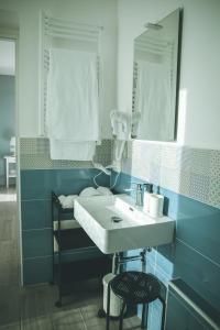 a bathroom with a sink and a mirror at B&B il Cappellaio di Erika in Brovello-Carpugnino