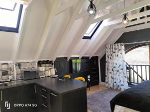 a kitchen with a black counter top in a room at Rozenhof Guest Cottages in George