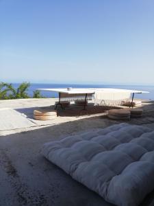 a picnic table and a sleeping mattress on the ground at Alicudi Giardino dei Carrubi- al gradino 365 in Alicudi