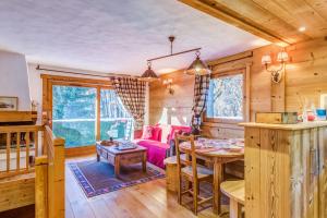 a dining room and living room in a log cabin at Charming flat in a chalet in Megève - Welkeys in Megève