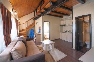 a living room with a couch and a kitchen at Club Satelit Zlatibor in Zlatibor