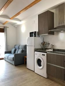 a kitchen with a refrigerator and a washing machine at Casa Rural La Cambreta - Chulilla in Chulilla