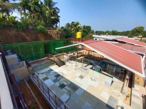 an overhead view of a building with a red roof at UDUPI HOMESTAY - Hill Top Villa - Dendoorkatte in Udupi