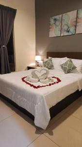 a bed with white sheets and pillows on it at FRA Dreams @ Swiss Garden Resort Residences in Kuantan