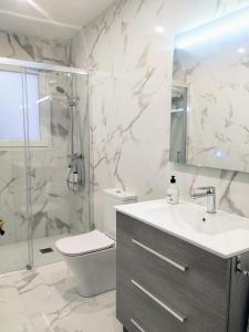 a bathroom with a sink and a shower and a toilet at Balcón del Cardenal in Baeza