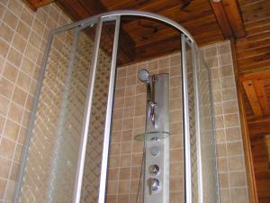 a shower with a glass enclosure in a bathroom at Dom w Szczyrku - stylowy drewniany dom z kominkiem in Szczyrk