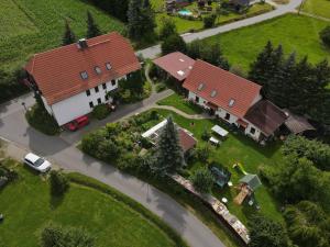 an overhead view of a large house with a red roof at Doppelzimmer Oybin in Herrnhut