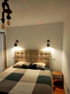 a bedroom with a large bed with lights above it at La Villa Romantica Résidence de vacances Les Tres Cales Espagne in Les tres Cales