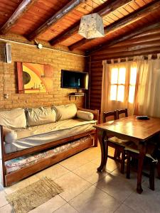 a living room with a couch and a table at Cabañas El Trigal in Nono +16 photos