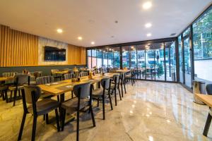 a restaurant with wooden tables and chairs and windows at Sirius Otel İstanbul in Istanbul