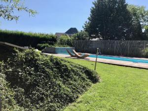 a yard with a swimming pool and a fence at Winning De Zwaen in Hasselt