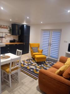 a living room with a couch and a table and chairs at Sunny Side - Self Catering Accommodation Gorey in Gorey