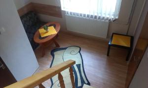 an overhead view of a living room with a table and a chair at Penzión Marína pri Slovenskej reštaurácii in Brezno