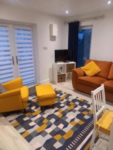 a living room with a couch and a tv at Sunny Side - Self Catering Accommodation Gorey in Gorey