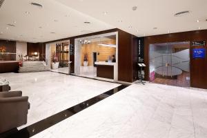 a lobby of a building with a reception desk at HCC St. Moritz in Barcelona