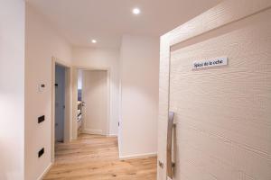 a white room with a door with a sign on it at Palazzo Chimelli in Pergine Valsugana