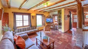 a living room with a couch and a table at Cortijo El Potro in Órgiva