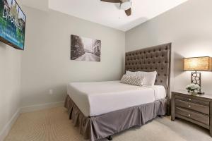 a bedroom with a large bed and a nightstand at Modern Condo with Game Room in Downtown New Orleans in New Orleans