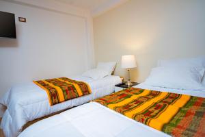twee bedden naast elkaar in een kamer bij Departamento KIRI familiar ó empresarial cerca al Aeropuerto de Juliaca- Perú in Juliaca