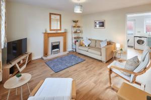 a living room with a couch and a fireplace at Host & Stay - Station Cottage in Saltburn-by-the-Sea