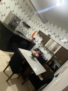 a kitchen with a table and chairs with a vase of flowers at Ilha do amor in Camocim