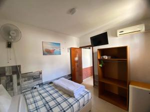 a hotel room with a bed and a tv and a room at Marina's Rooms in Larnaca