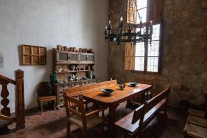 a dining room with a wooden table and chairs at Mas de Paco, Chimenea, barbacoa y piscina in Vall dʼAlba