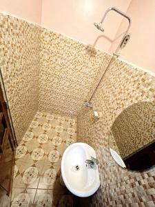 a bathroom with a sink and a mirror at we are one apartment in Arusha