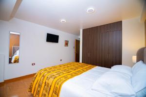 En eller flere senge i et værelse på Apartahotel KIRI para empresas y familias que viajan en grupo cerca del Aeropuerto Juliaca Perú