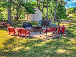a playground with red benches and a swing at Waterway Inn in Indian River